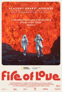 Fire of Love documentary poster: two people in silver fire suits walk in front of the mouth of an erupting volcano- the entire background is lava